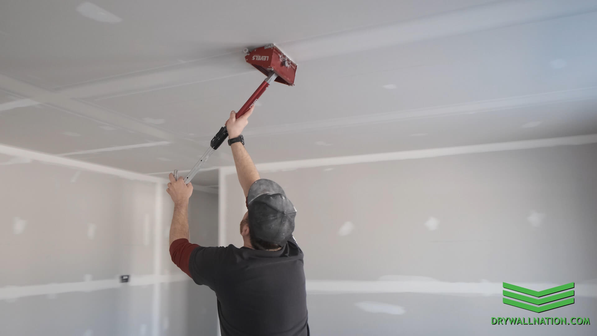 Damaged drywall surface after wallpaper removal being prepared for skim coating