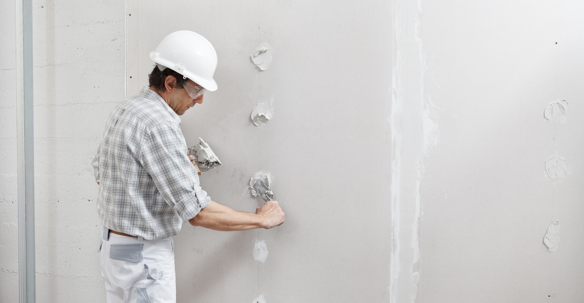Repairing a crack in drywall within an arid climate home, with a desert view from the window