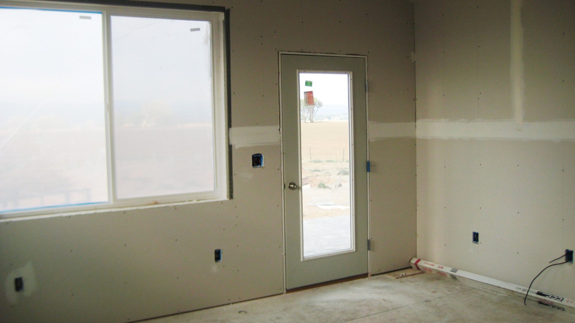 Drywall showing indicators of humidity damage, such as peeling paint and mold spots
